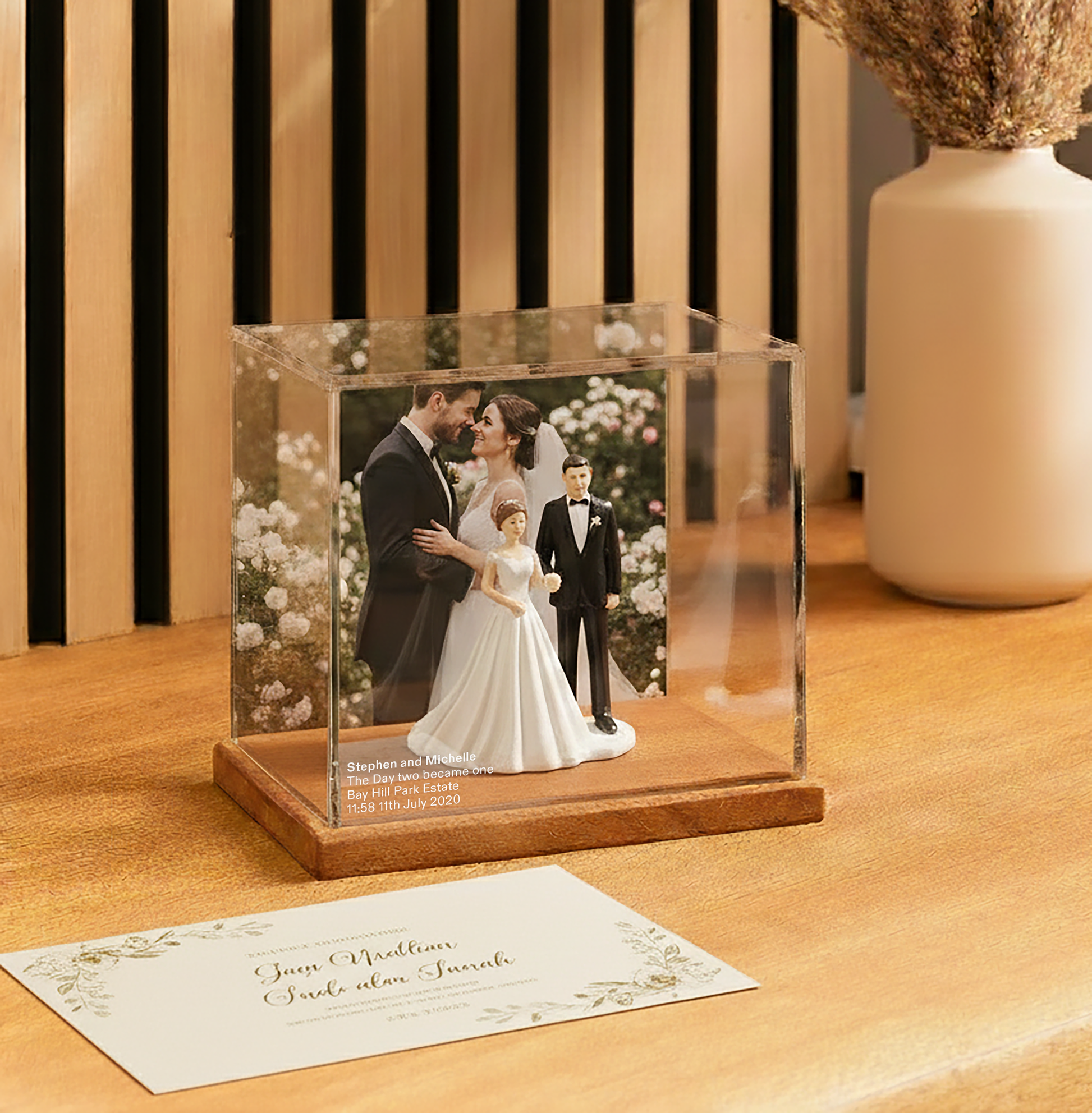 Wedding Memory display case with a wedding couple figurine on a wooden surface.