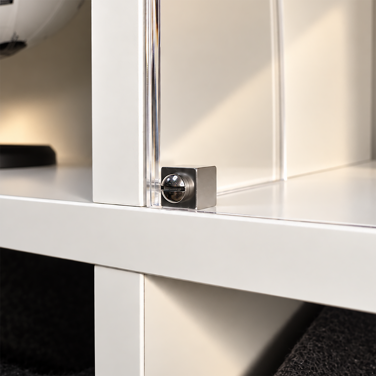 Close-up of the stainless steel cube connector and screw that fix the acrylic front panel to the side panel