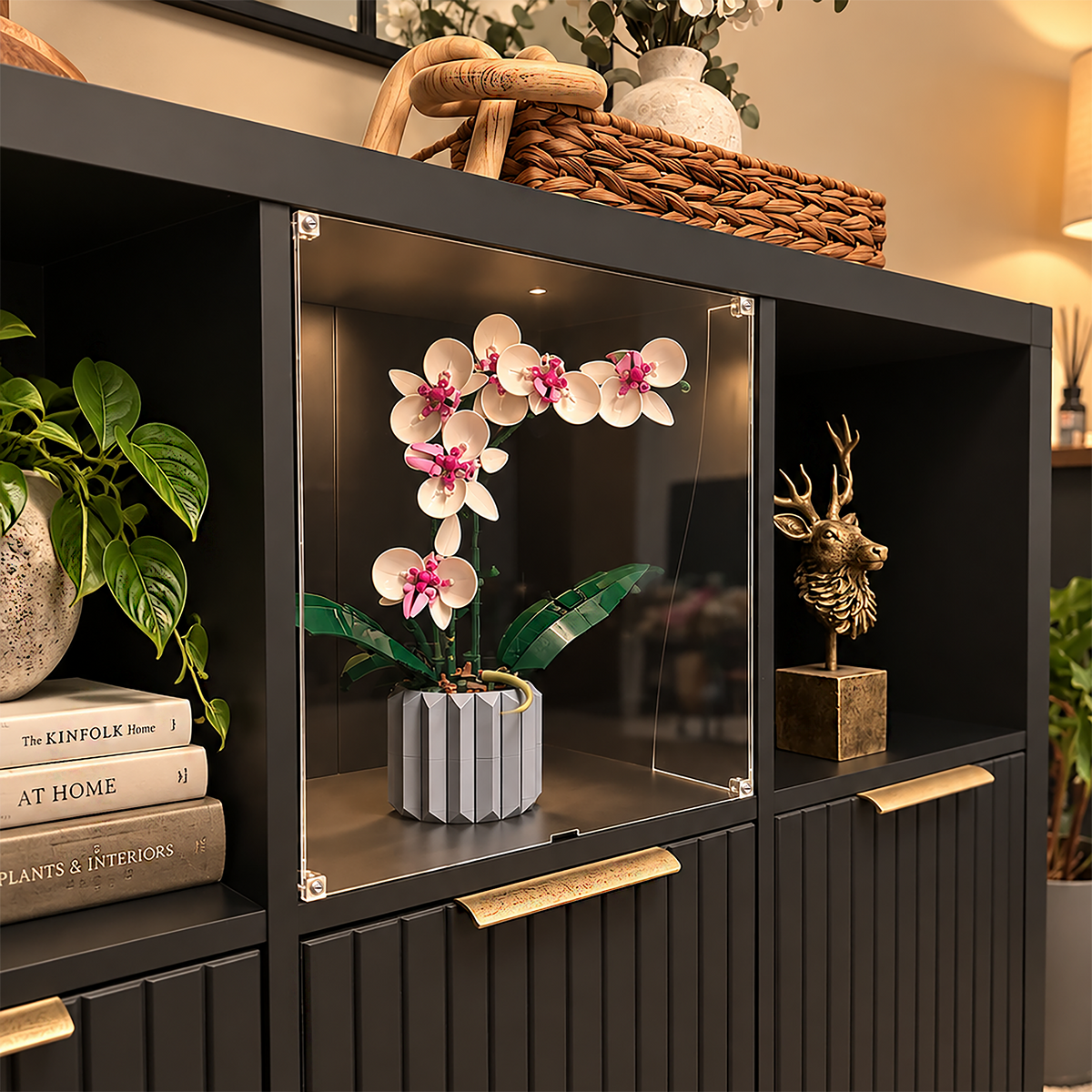 Clear acrylic display window insert in a black IKEA KALLAX cubby, protecting a brick-built orchid model