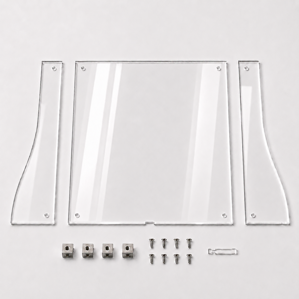 Kit contents laid flat: front panel, two shaped side panels, four stainless steel cube connectors, eight screws and the clear pull tab